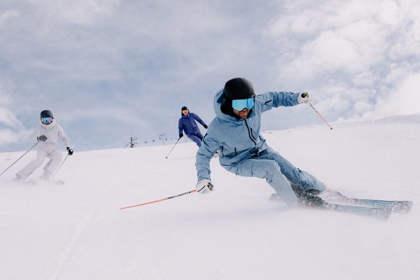 A person skiing down a slope dressed in blue.