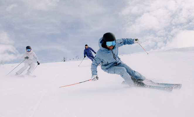 A person skiing down a slope dressed in blue.