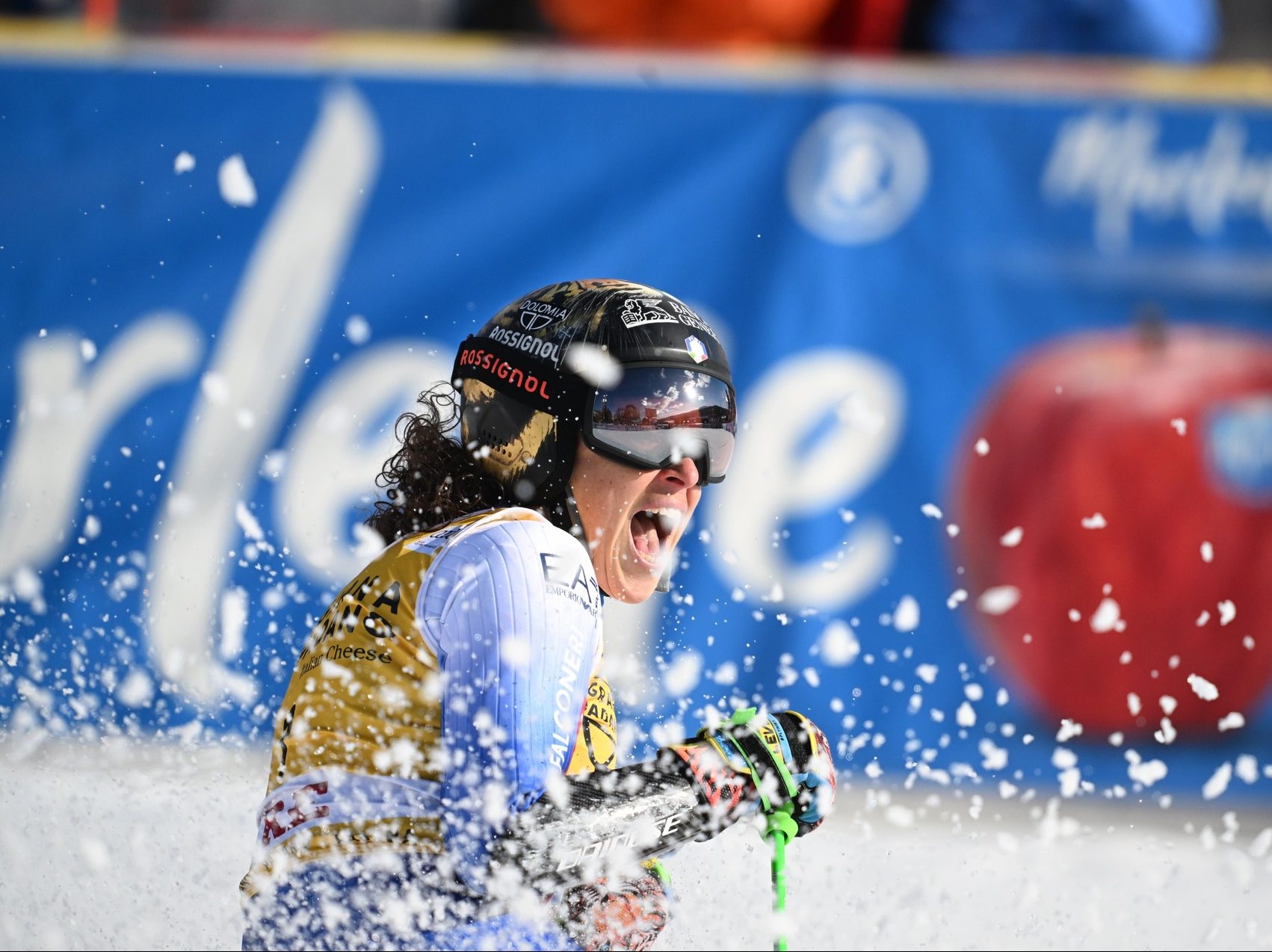 Federica Brignone celebrating her performance, wearing her helmet featuring a tiger design.