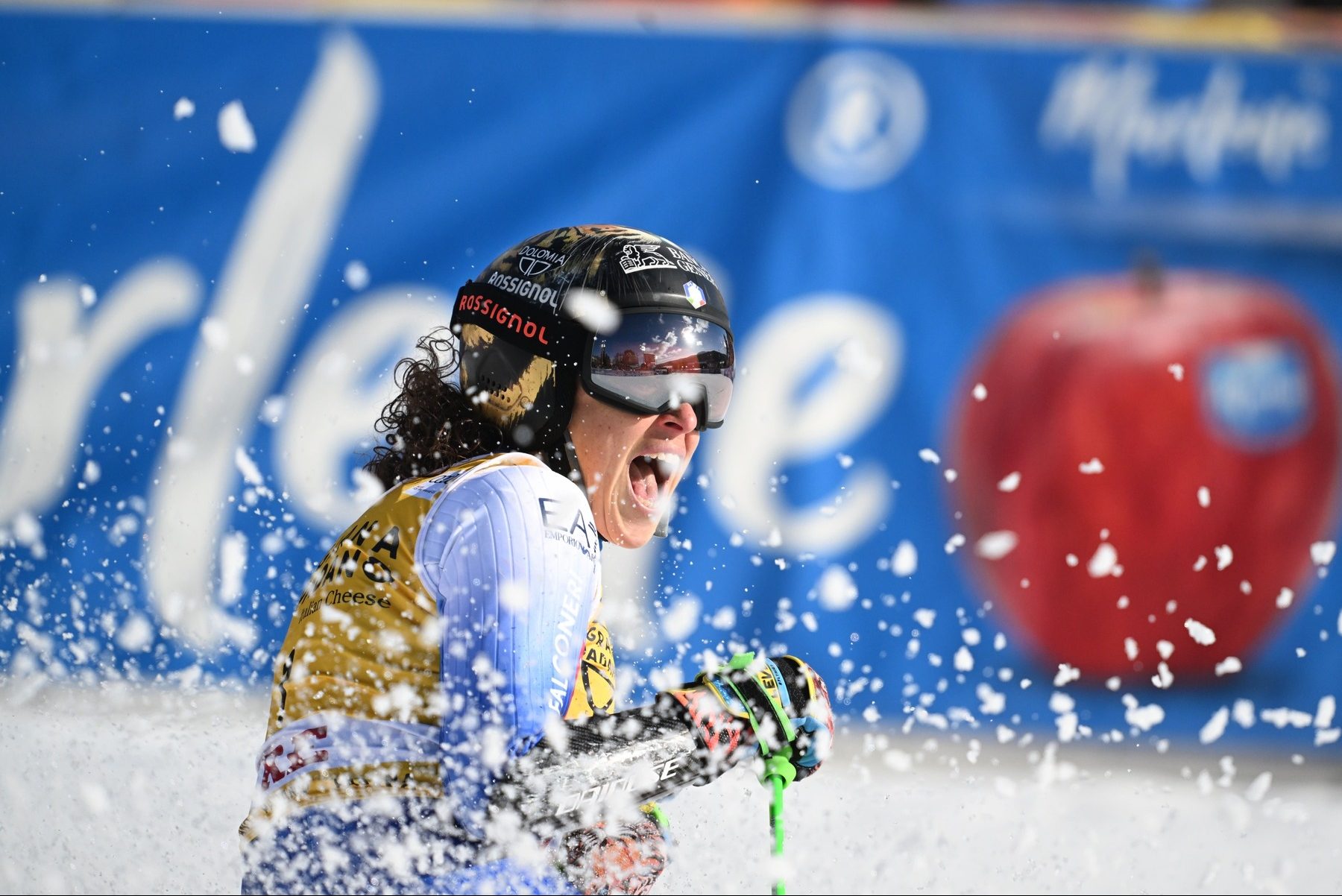 Federica Brignone célébrant sa performance, portant son casque avec un tigre